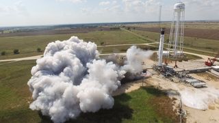The SpaceX Falcon 9 rocket that will launch the crewed Demo-2 mission to the International Space Station undergoes a static fire test in McGregor, Texas, on Aug. 29, 2019.