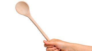 Holding a wooden spoon