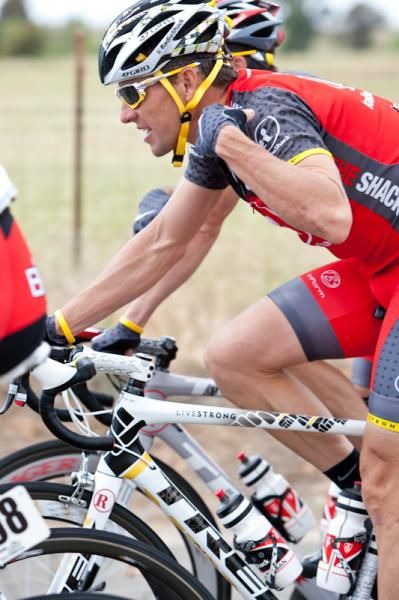 Lance Armstrong (Radioshack) taking care of a little itch around the collar.