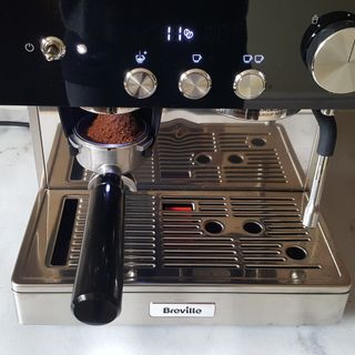 The Breville Barista Signature Espresso Machine being tested in a kitchen with a grey marble worktop