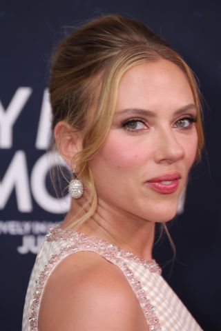 a close up of scarlett johansson on the Fly Me to the Moon red carpet wearing a pink gingham set.
