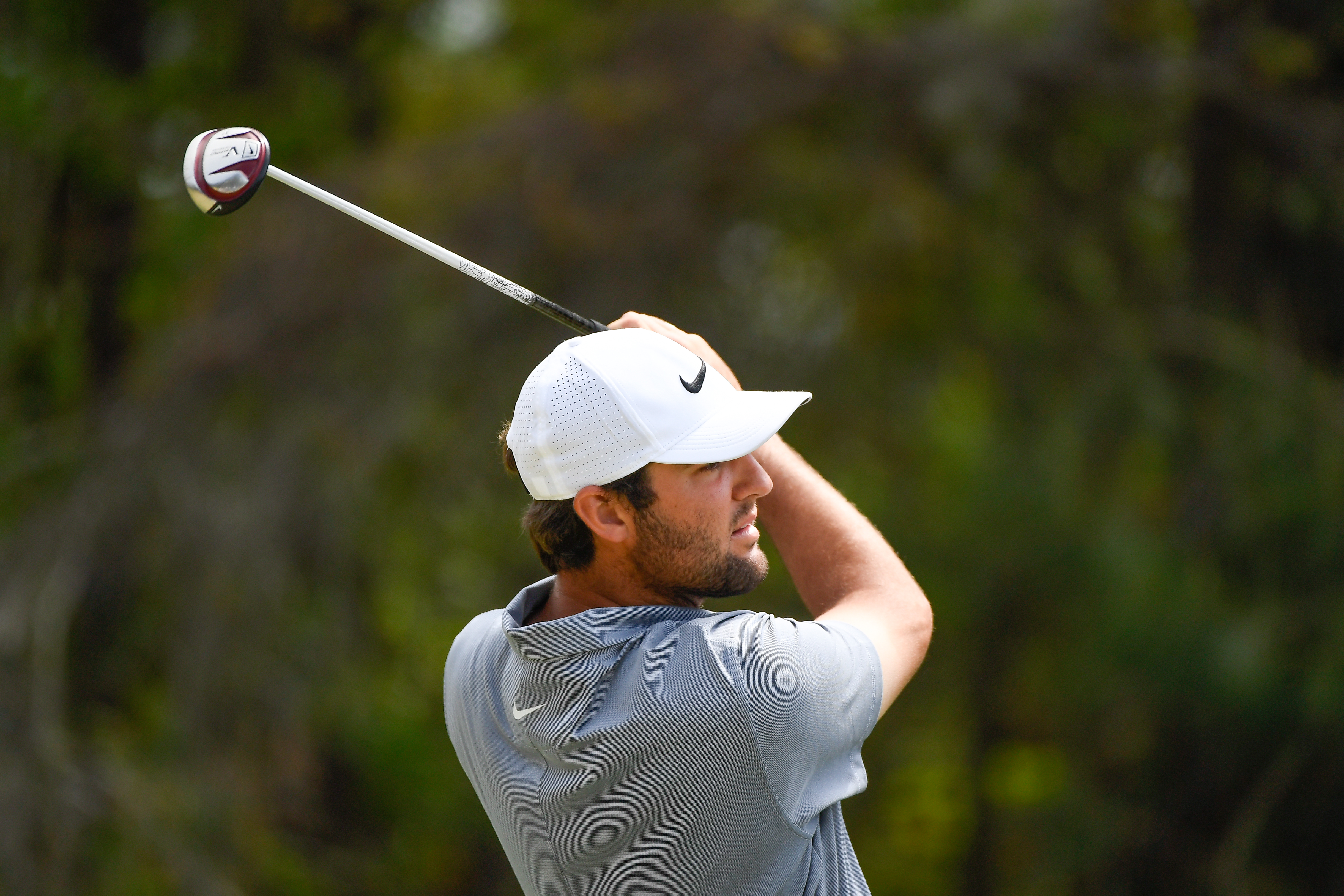 Scottie Scheffler hits a fairway wood off the fairway
