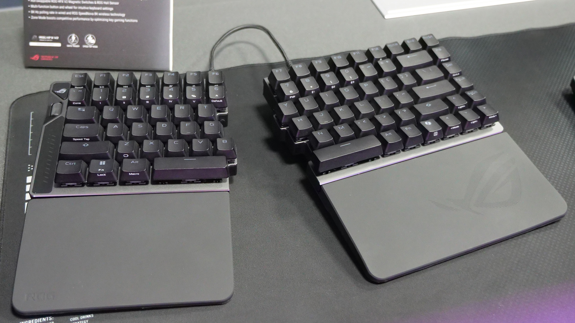 Asus ROG Falcata gaming keyboard split apart on a mousepad.