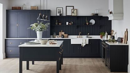 Organizing under the sink: Kitchen Makers Haddon kitchen with dark cabinets and island