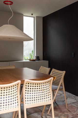 A small dining room with a pendant light above