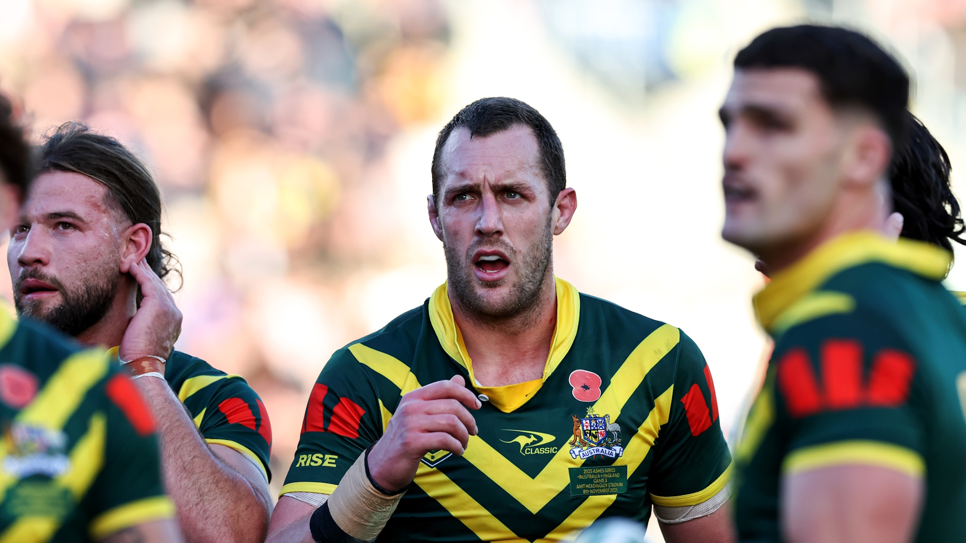 Isaah Yeo and and Patrick Carrigan of Australia watch a video replay during a rugby league match.