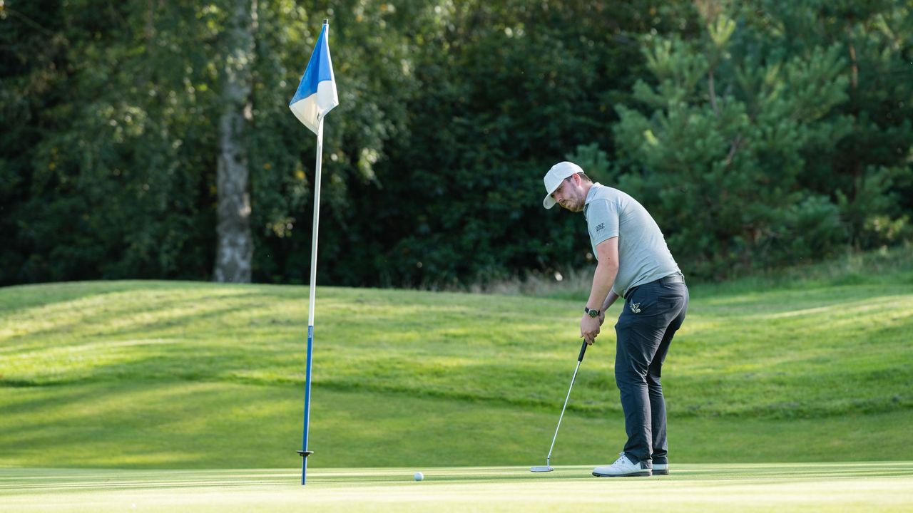 Golfer putts a ball