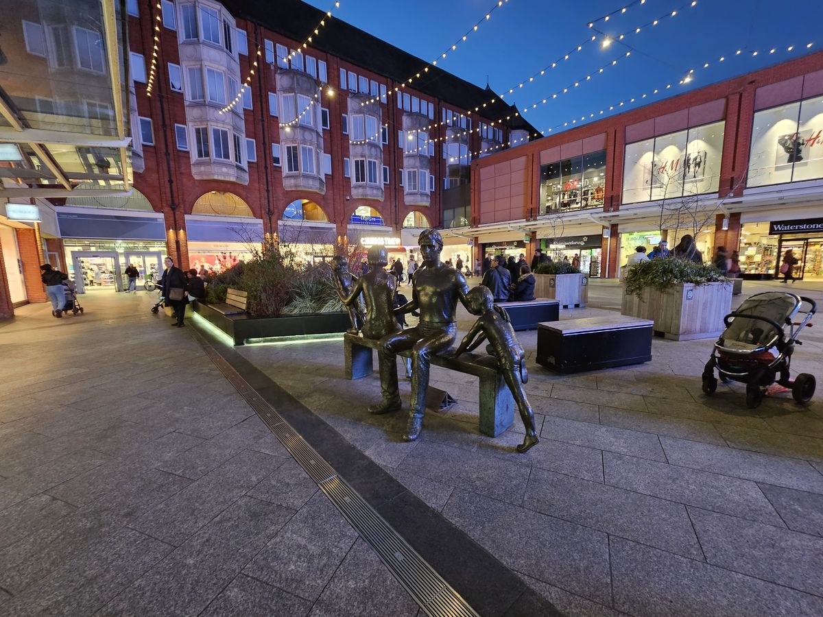 statues of a man and children