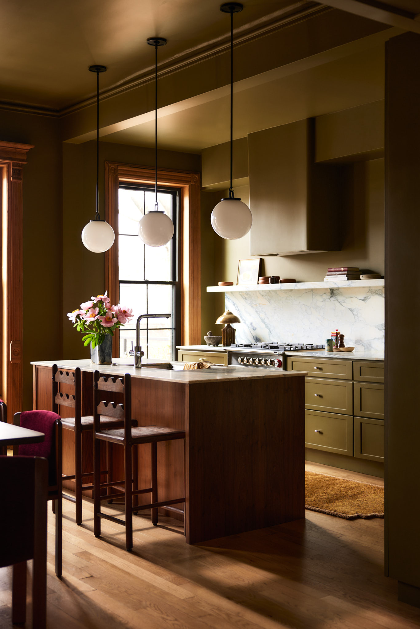 Small wood-drenched kitchen with olive green cabinetry, walls, and ceiling