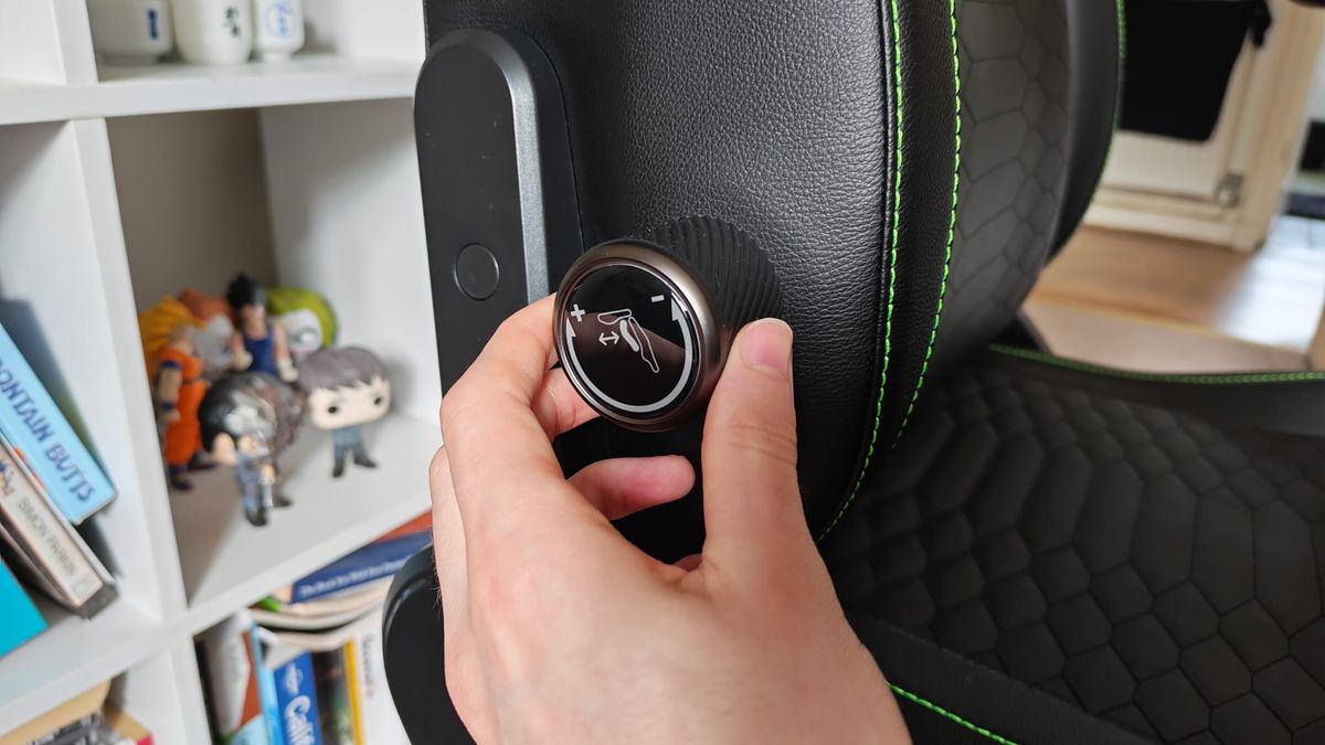 A reviewer using the lumbar adjustment controls on the Razer Iskur V2 NewGen