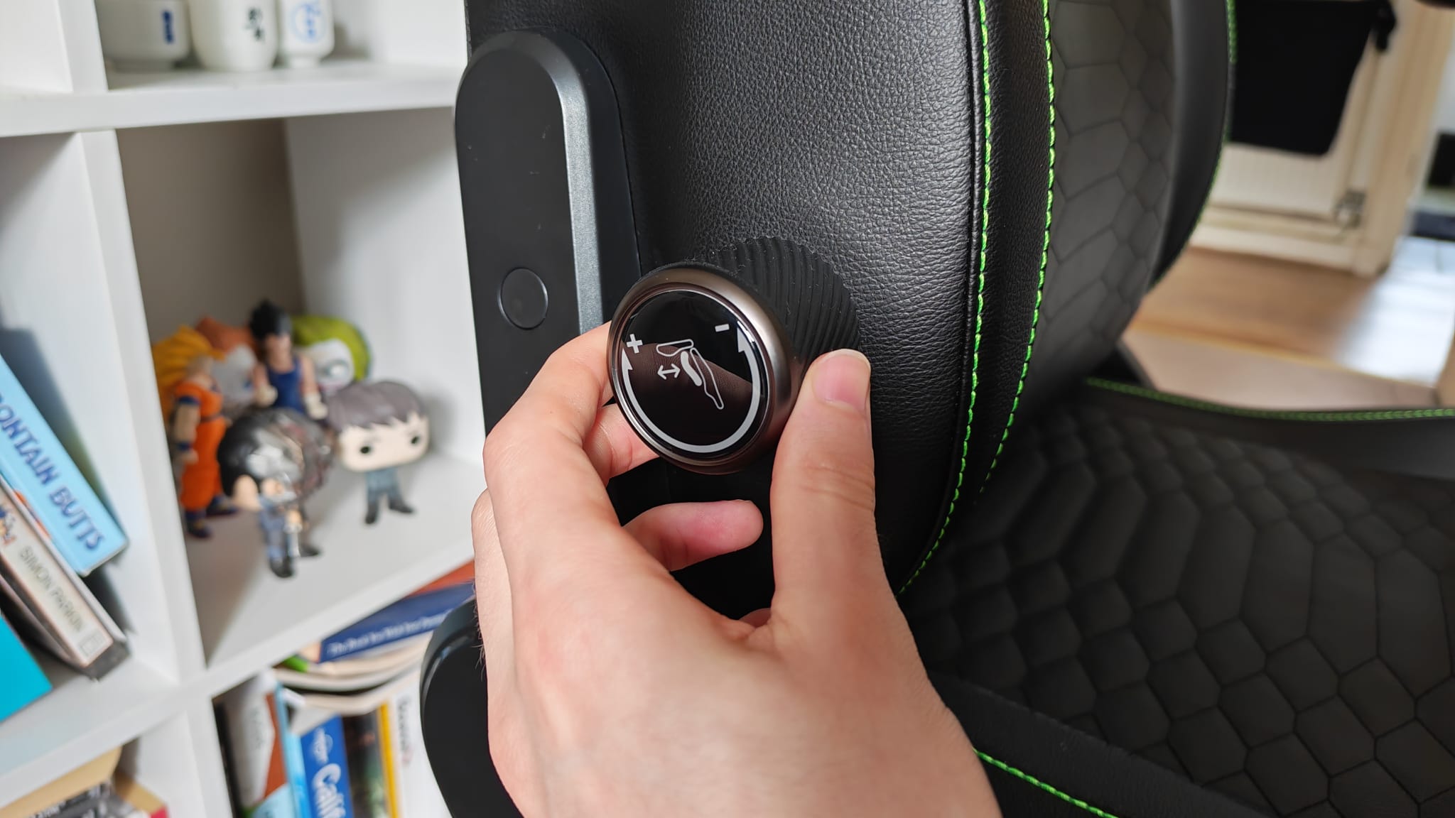 A reviewer using the lumbar adjustment controls on the Razer Iskur V2 NewGen