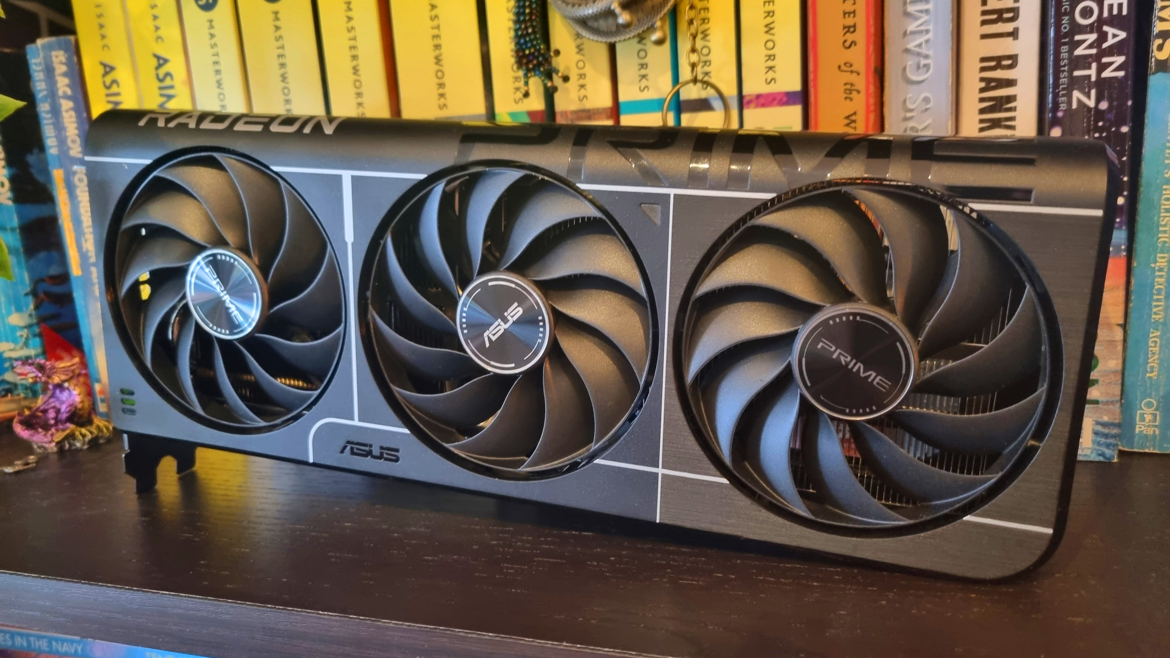 An Asus Prime Radeon RX 9060 XT 8 GB graphics card on a bookshelf, looking all attractive