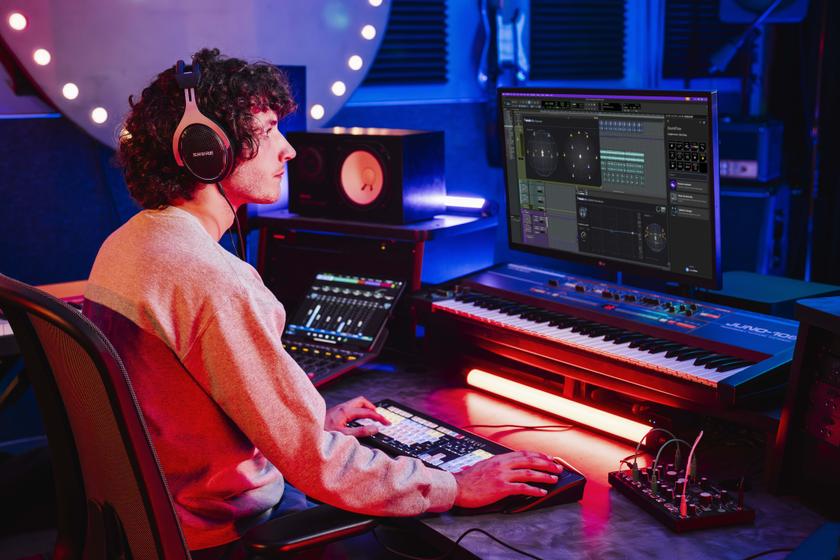 Avid user working on a computer and electronic piano.