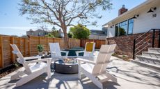 Retro Americana patio area by Studio SQUIRE styled with a trio of matte black outdoor gooseneck barn lights lining the exterior