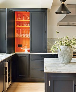 Colorful kitchen with blue and orange painted cabinetry