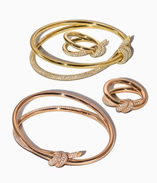 Jewellery that circles the body in a fluid loop secured by a coiled knot.