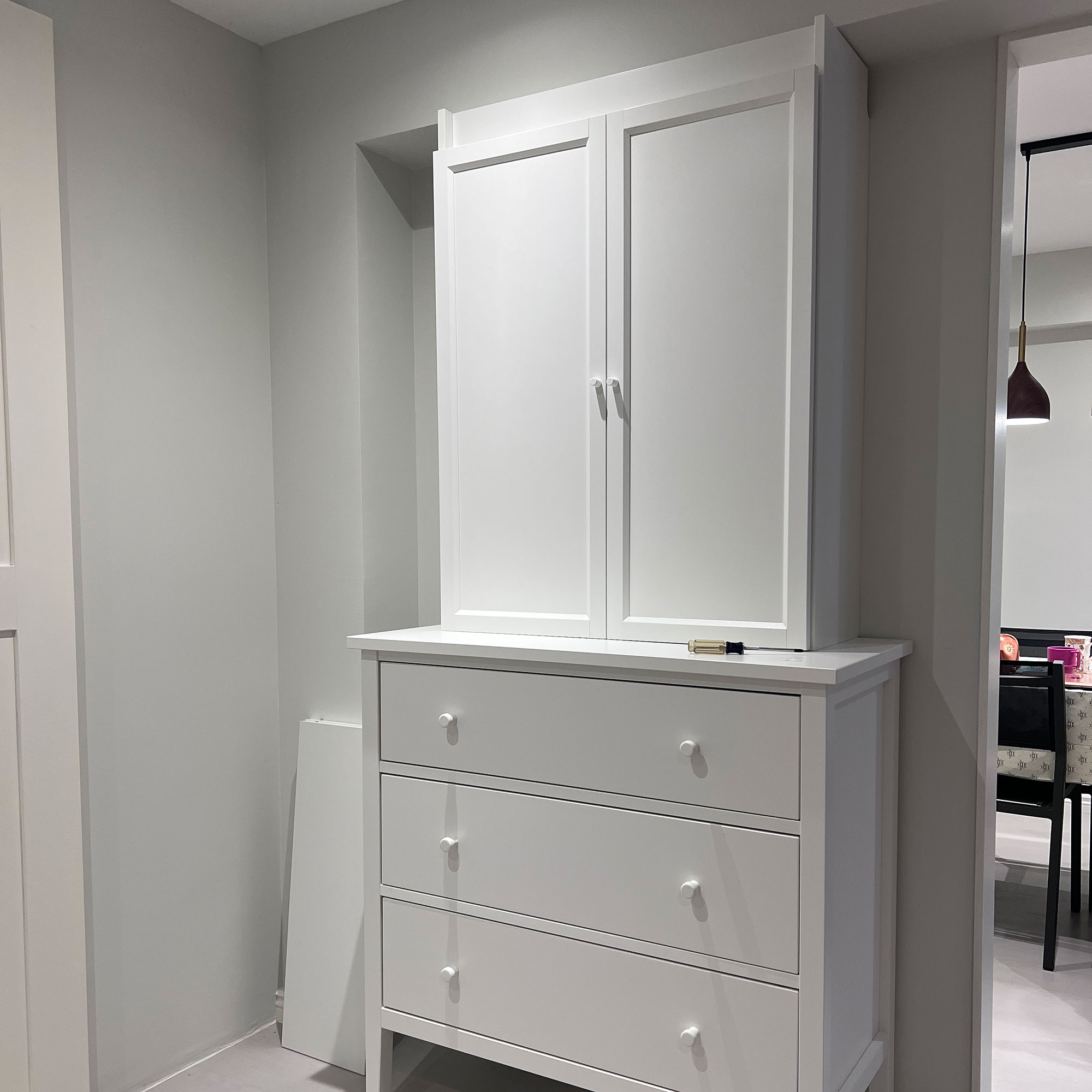 White cupboard and drawers in neutral hallway