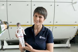 European Space Agency (ESA) astronaut Samantha Cristoforetti holds Mattel's new Barbie Signature Role Model doll that was styled after her.