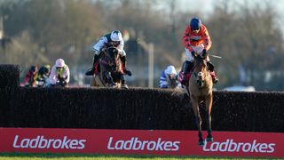 Harry Cobden riding Bravemansgame (orange) clear the last to win The Ladbrokes King George VI Chase at Kempton Park Racecourse on December 26, 2022 in Sunbury, England.