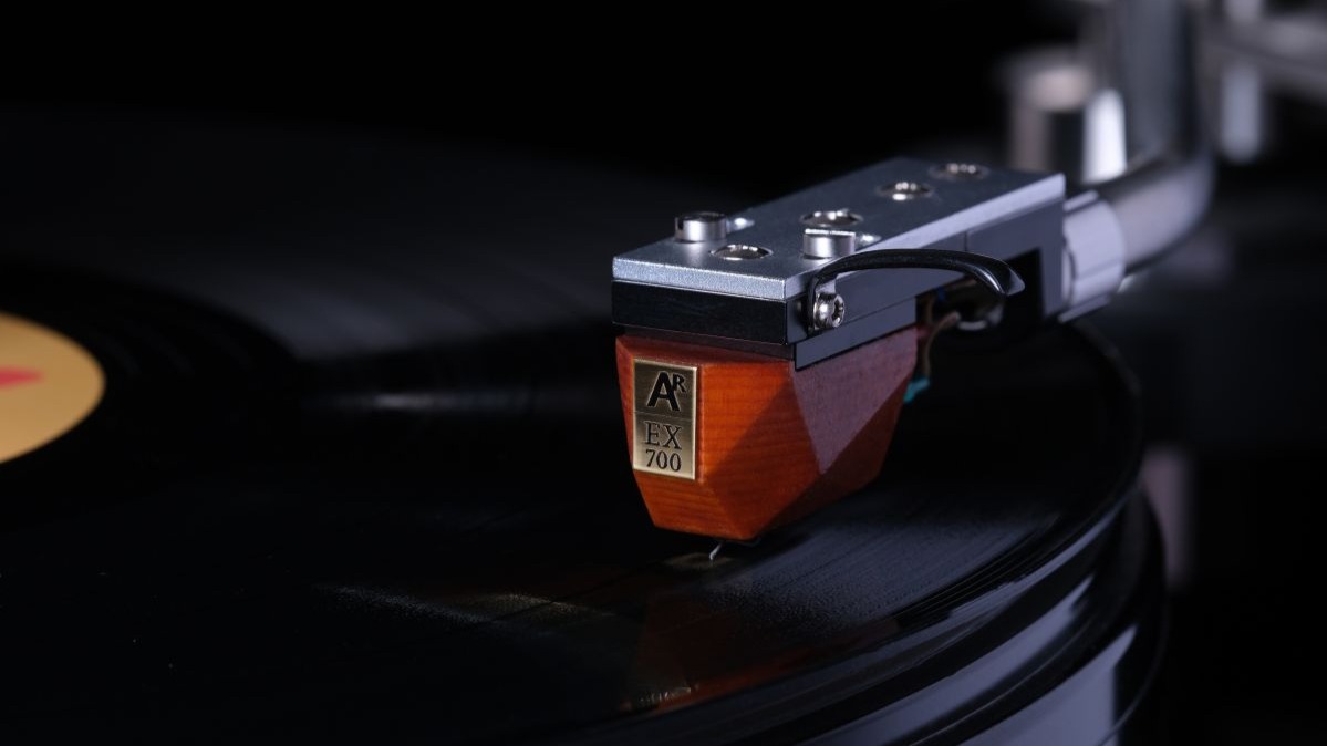 Analog Relax EX700 cartridge with a wooden body playing on a black vinyl record 