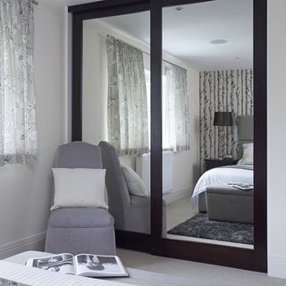 mirror on a closet door is an attractive way to visually increase the size of a room