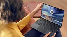 Woman holding Dell laptop
