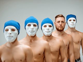 Men with their faces painted white.
