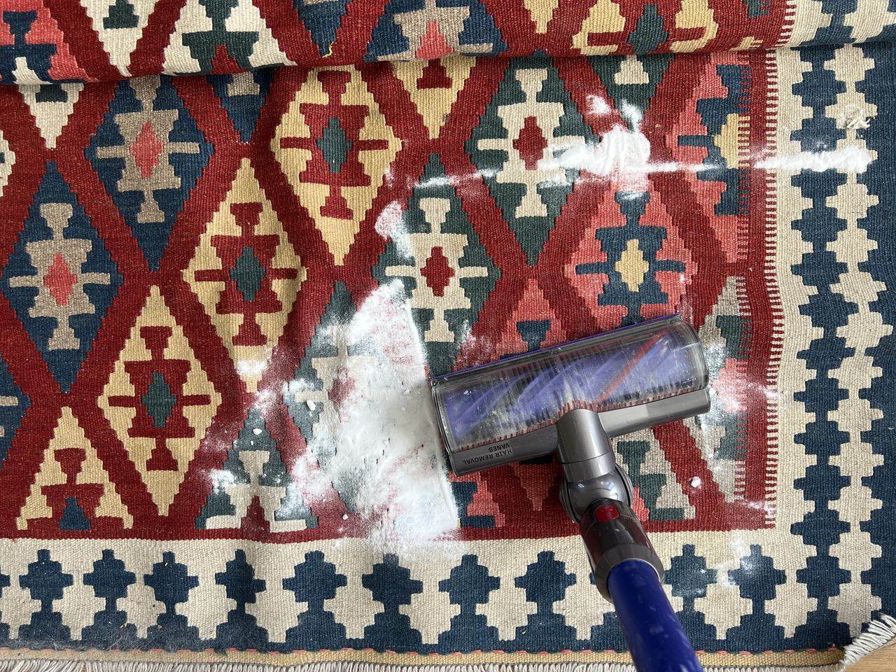 Vacuuming baking soda off of rug