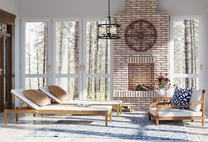 Bright and airy sunroom with loungers, an arm chair and an exposed brick wall