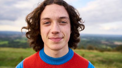 A teenaged boy smiles.