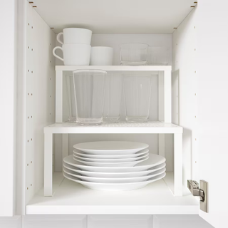 A kitchen cabinet with shelf risers