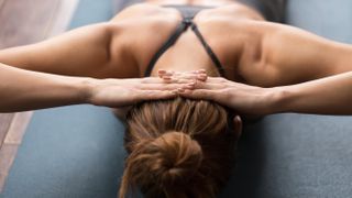 a woman lying face down on an exercise mat