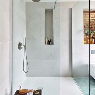 walk in shower with niche shelving in wall
