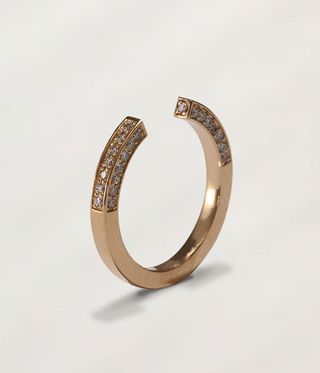 Moritz Glik Ring with a gold-cased diamond cube and two surrounding small diamond.
