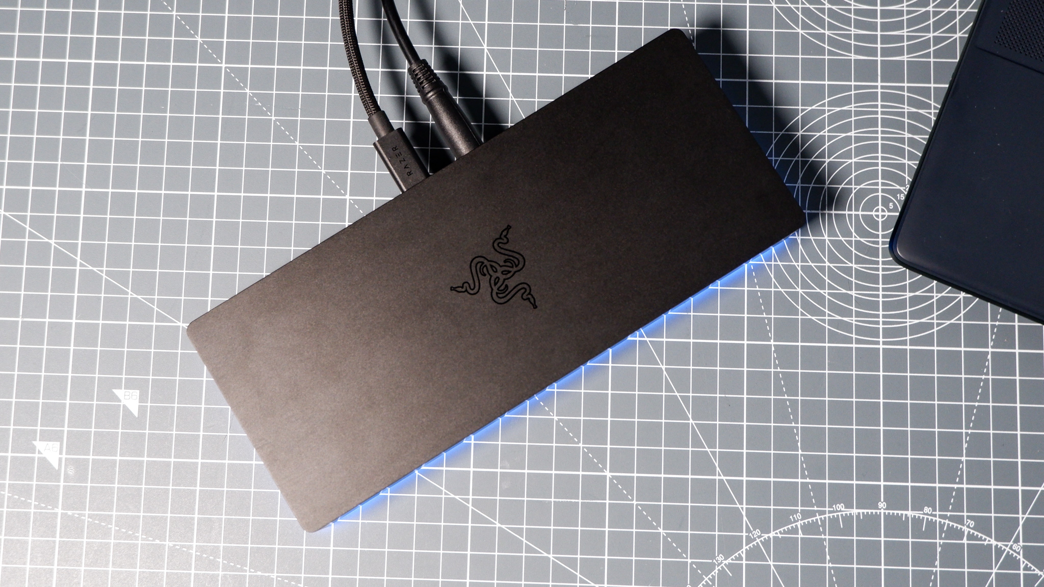 The Razer Thunderbolt 5 Dock on a desk with the RGB enabled and an SSD installed.