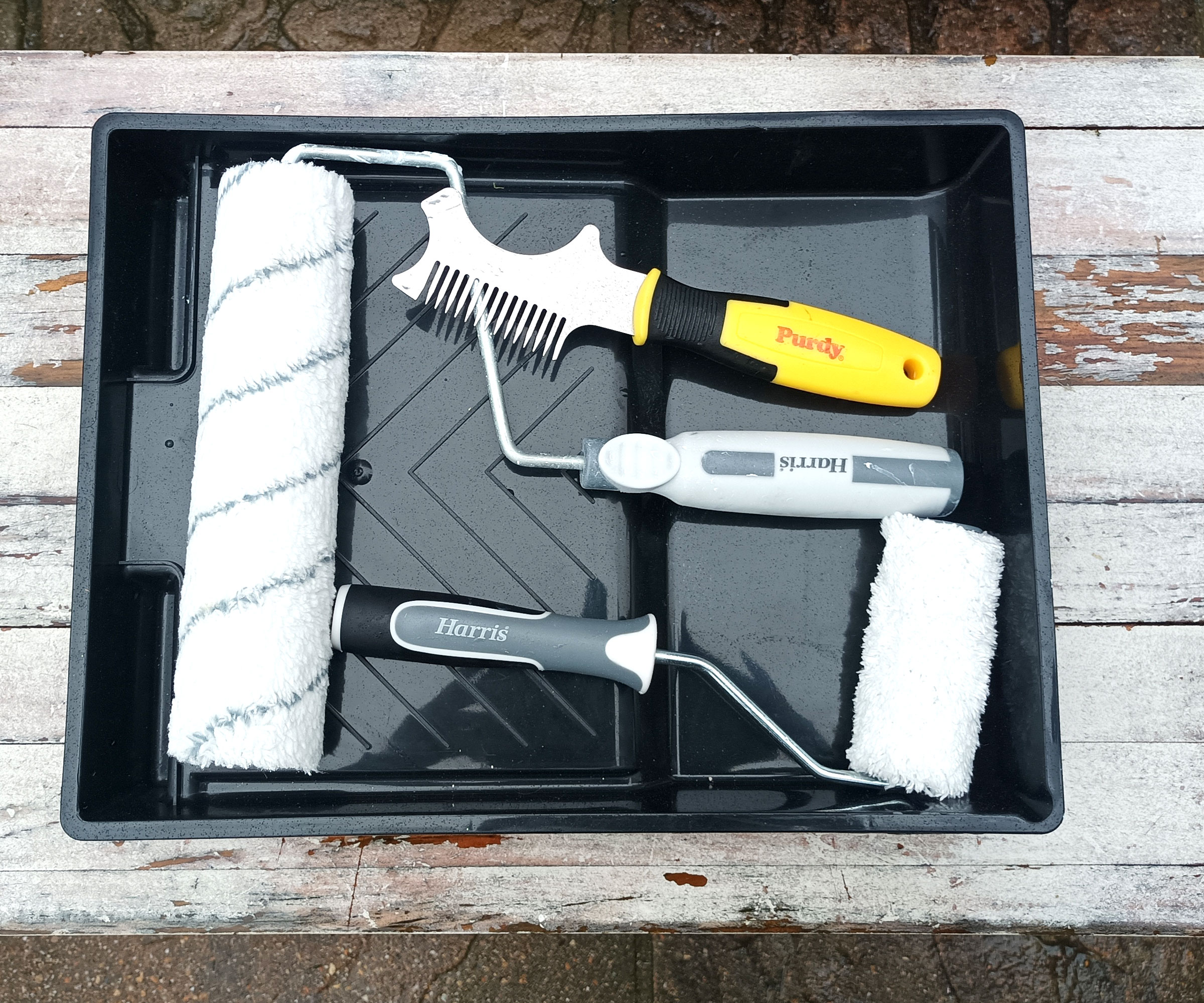 Harris roller tray with 9-inch and 4-inch roller alongside a Purdy brush and roller cleaner