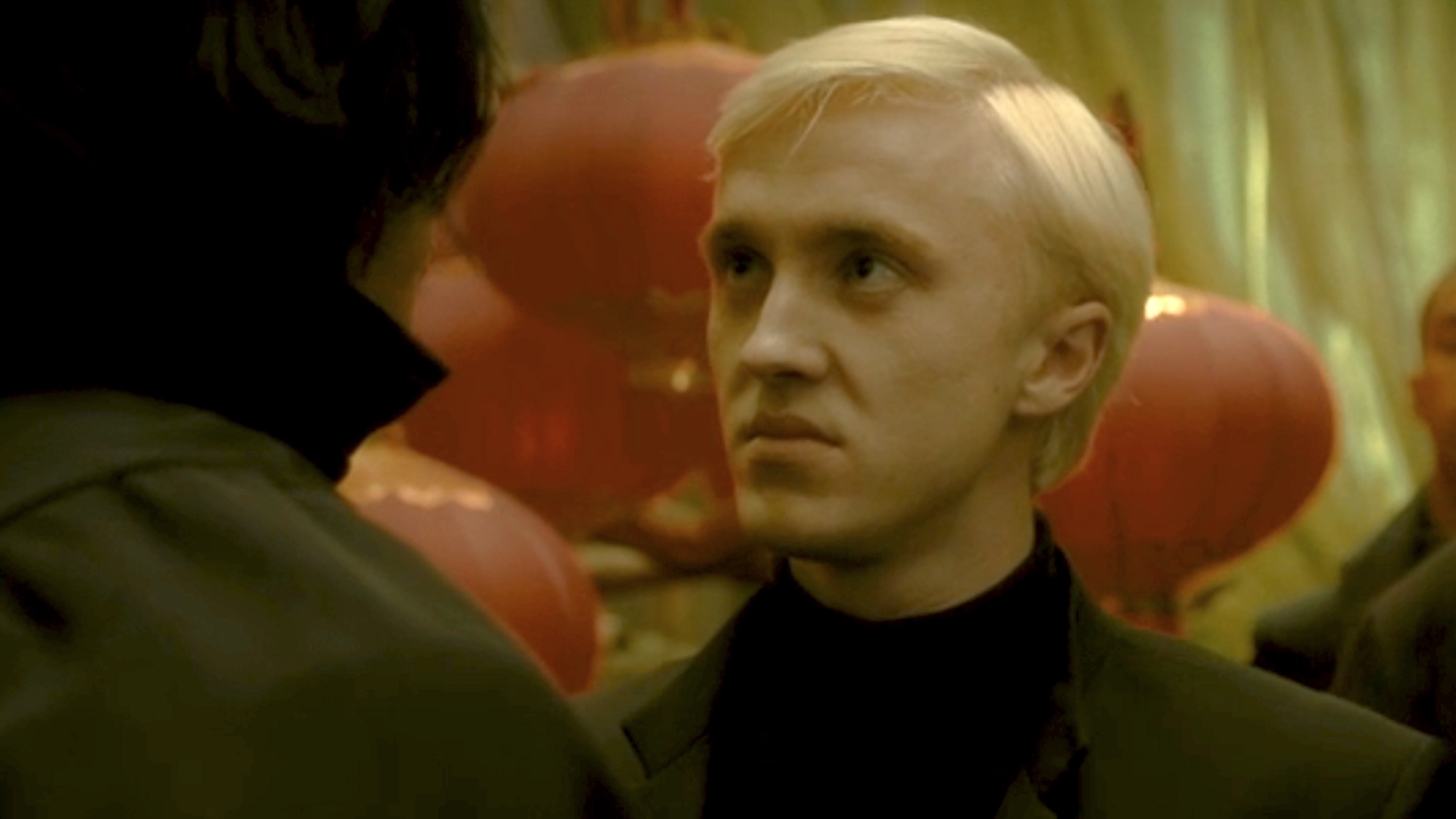 Draco frowning at Snape in Harry Potter and the Half-Blood Prince