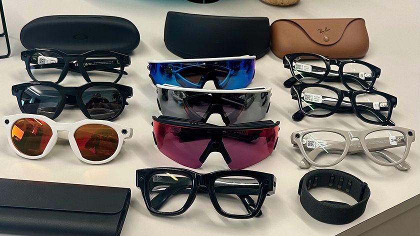 Three Oakley Meta HSTN, three Oakley Meta Vanguard, and three Ray-Ban Meta (Gen 2), along with cases, sitting atop a table in various styles, along with the Meta Ray-Ban Display glasses in front of them all.