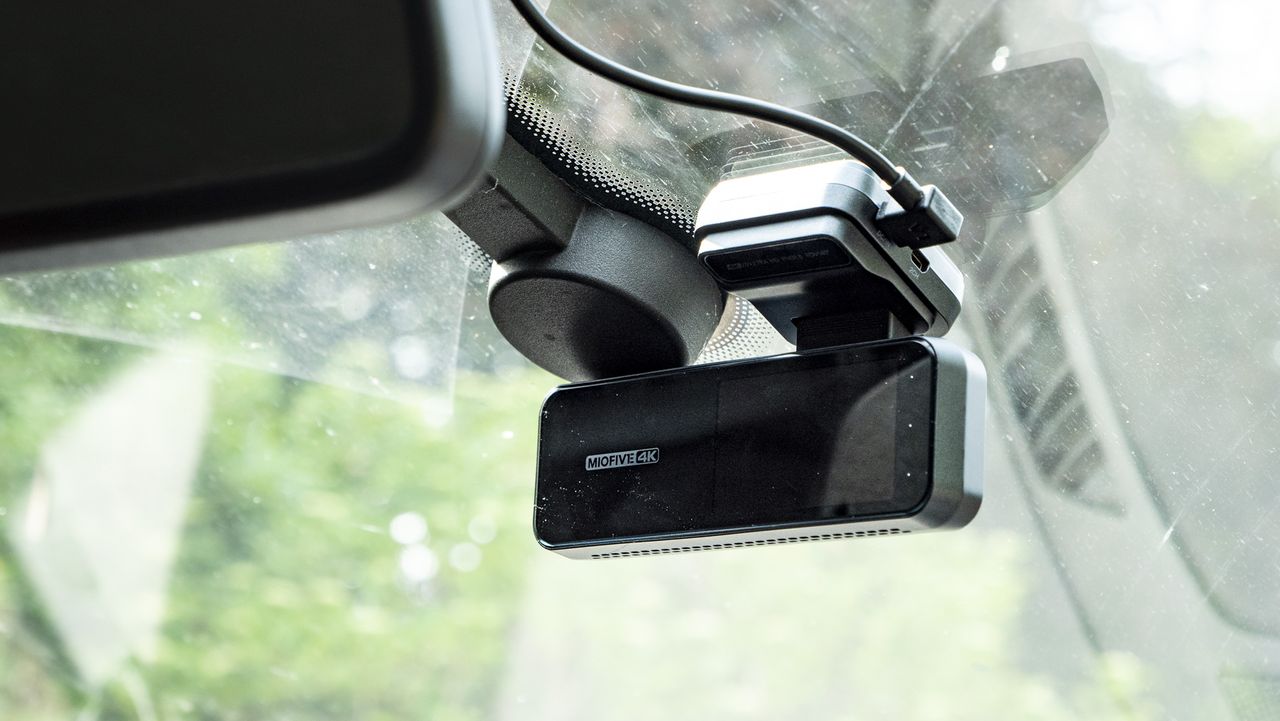 Miofive Dual Dash Cam front camera in position on a windscreen