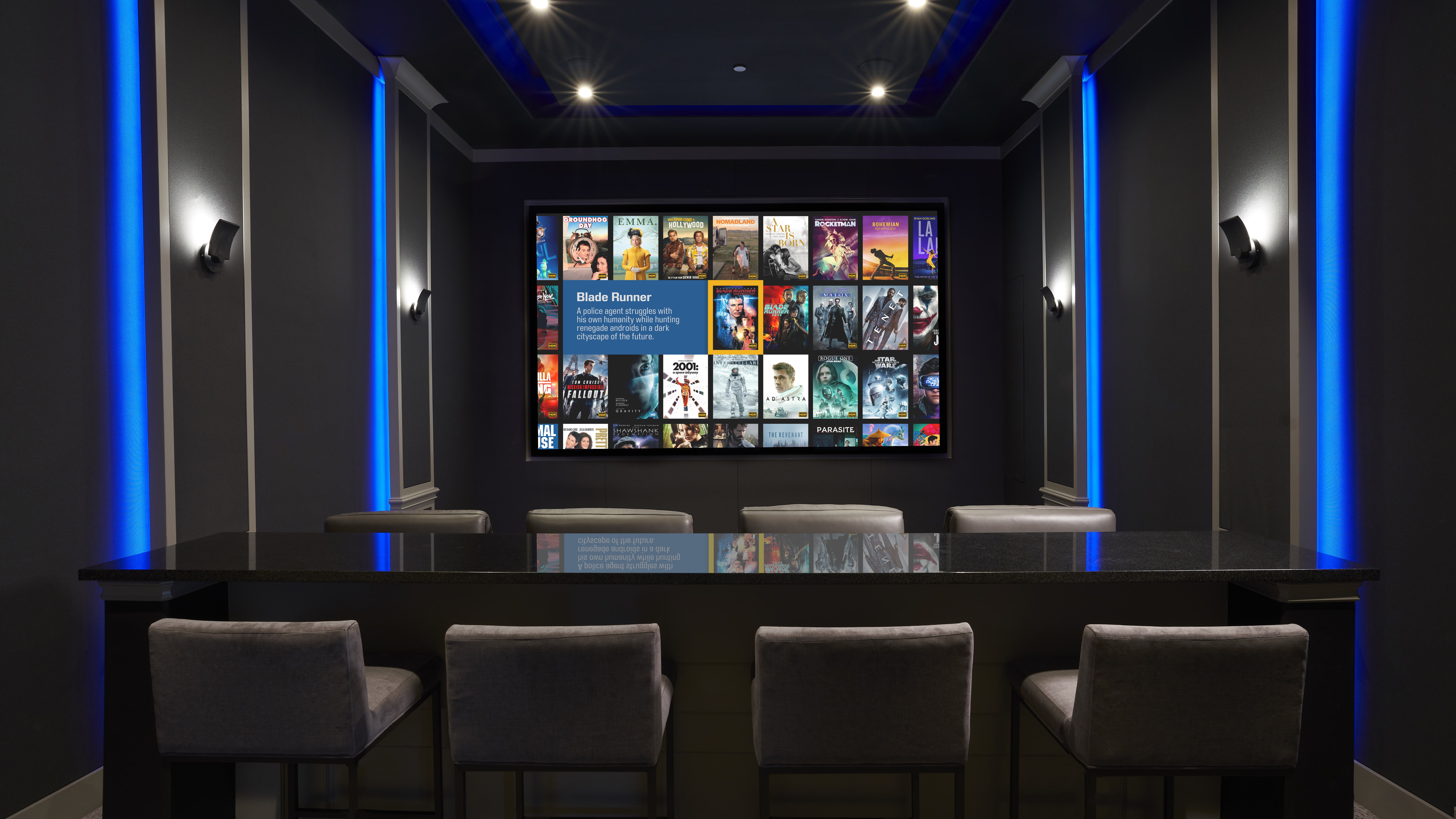 Home theater space showing comfortable seating and screen with Kaleidescape interface