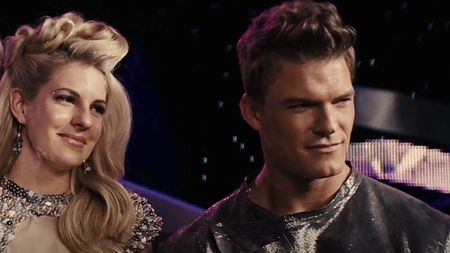 Alan Ritchson and Stephanie Leigh Schlund as Cashmere and Gloss being interviewed by Caesar in The Hunger Games: Catching Fire.