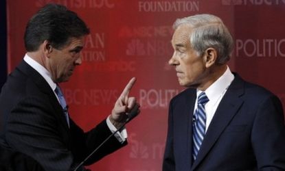Behind the scenes at Wednesday night's GOP debate, Gov. Rick Perry appears to give fellow Texan Rep. Ron Paul a stern talking to.