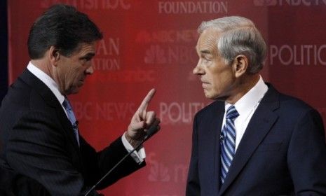 Behind the scenes at Wednesday night&amp;#039;s GOP debate, Gov. Rick Perry appears to give fellow Texan Rep. Ron Paul a stern talking to.