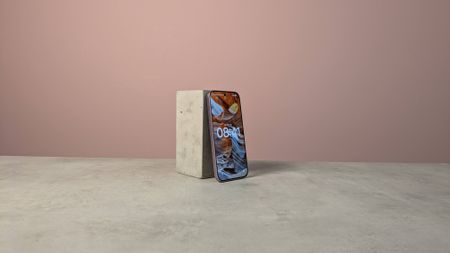 Three-quarter view of Xiaomi 17T on a desk with pink wall in background