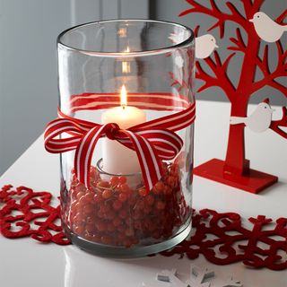 Christmas lantern with cranberries and red ribbon