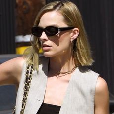 Margot Robbie paired a linen vest suit set with a new Chanel Flap Bag