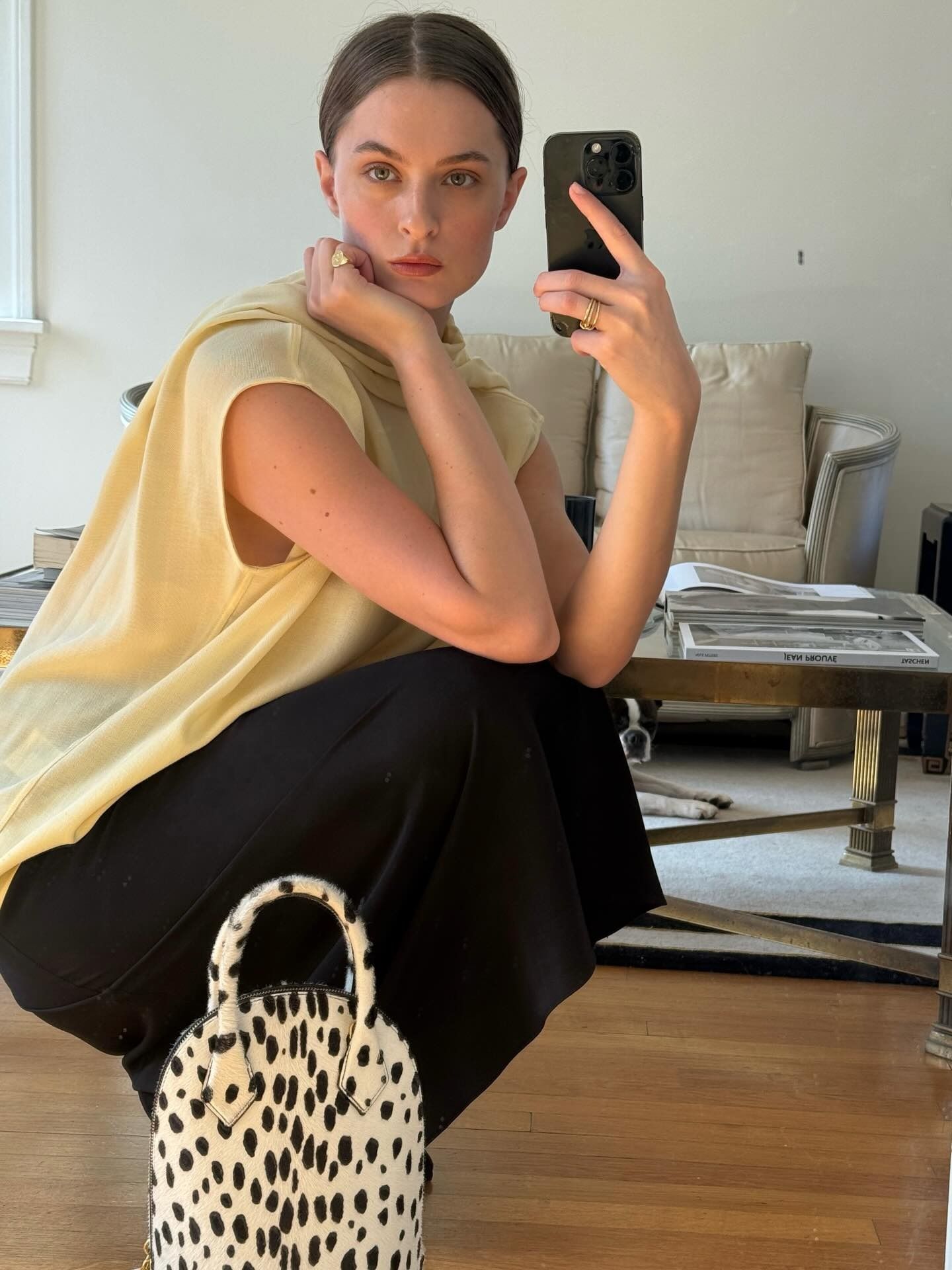 @christietyler in Toteme, Ala&iuml;a bag, and black skirt
