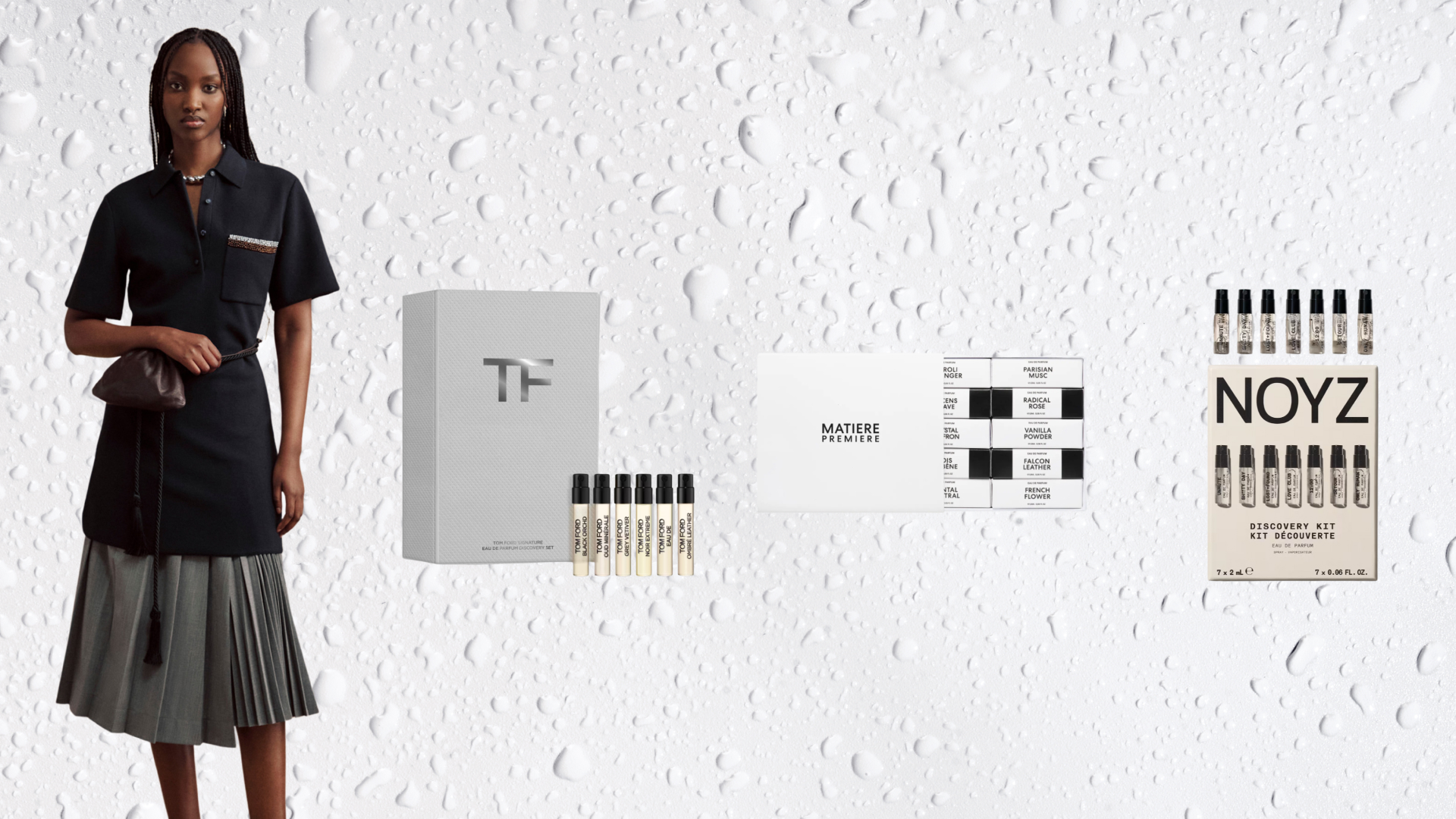 A model with long braids standing next to various perfume sampler sets on a white background with liquid droplets on it. 