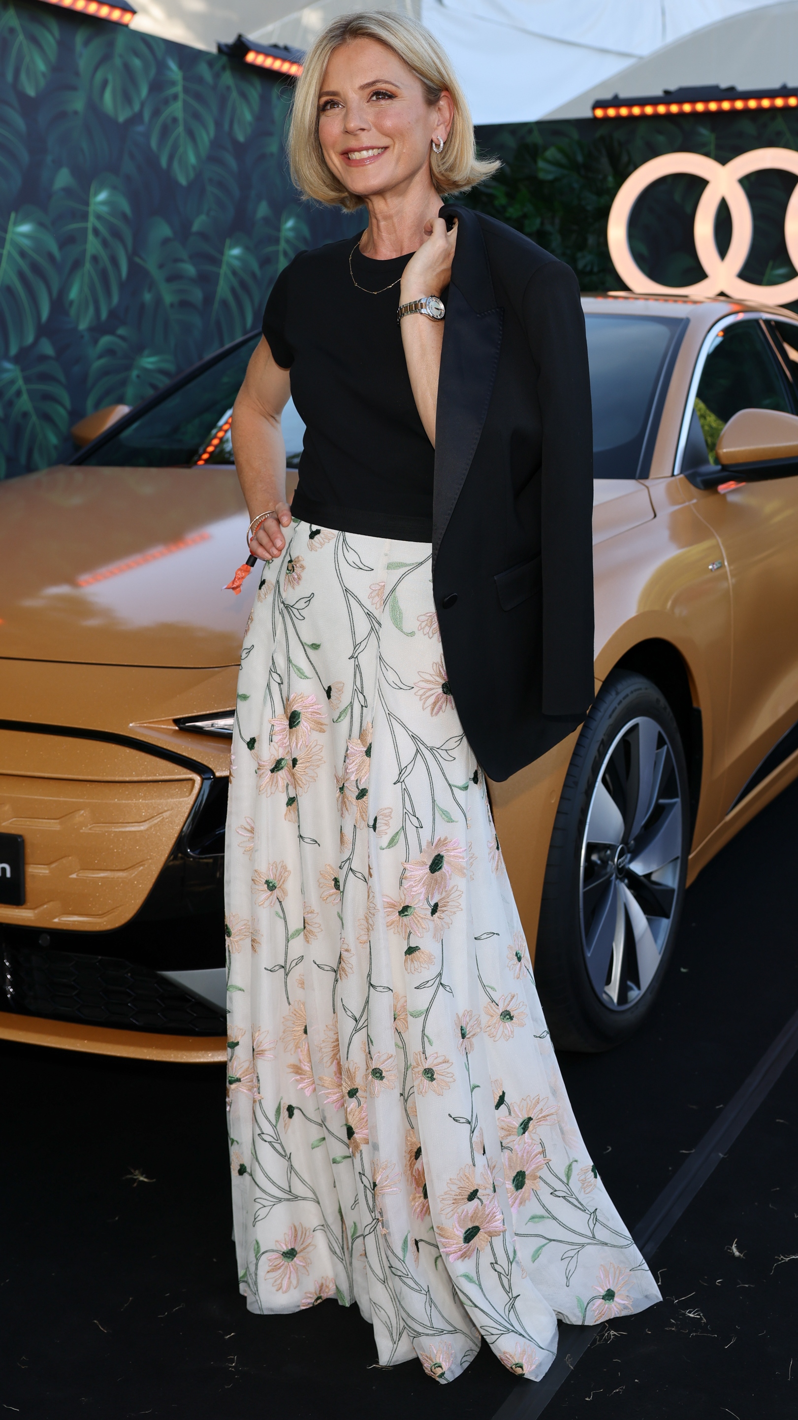 Emilia Fox poses for photographs in front of a car as she joins Audi at the Henley Festival 2025 on July 10, 2025