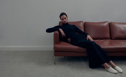 Model sitting on sofa